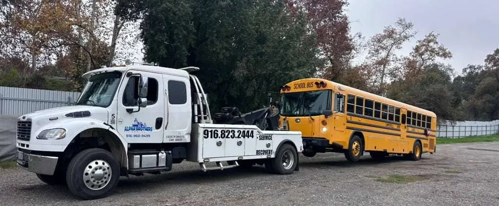 Alpha Brothers towing a bus in Sacramento — school, transit, and charter bus recovery