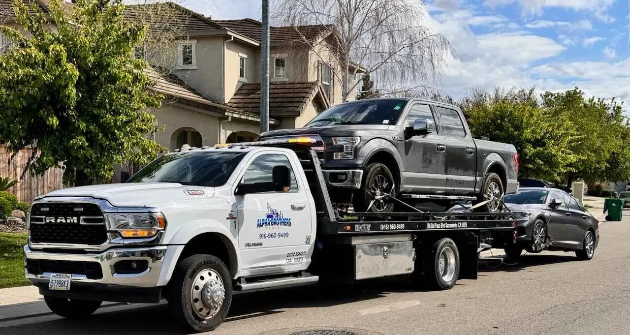 Alpha Brothers flatbed tow truck on a Sacramento road ready for damage-free vehicle transport