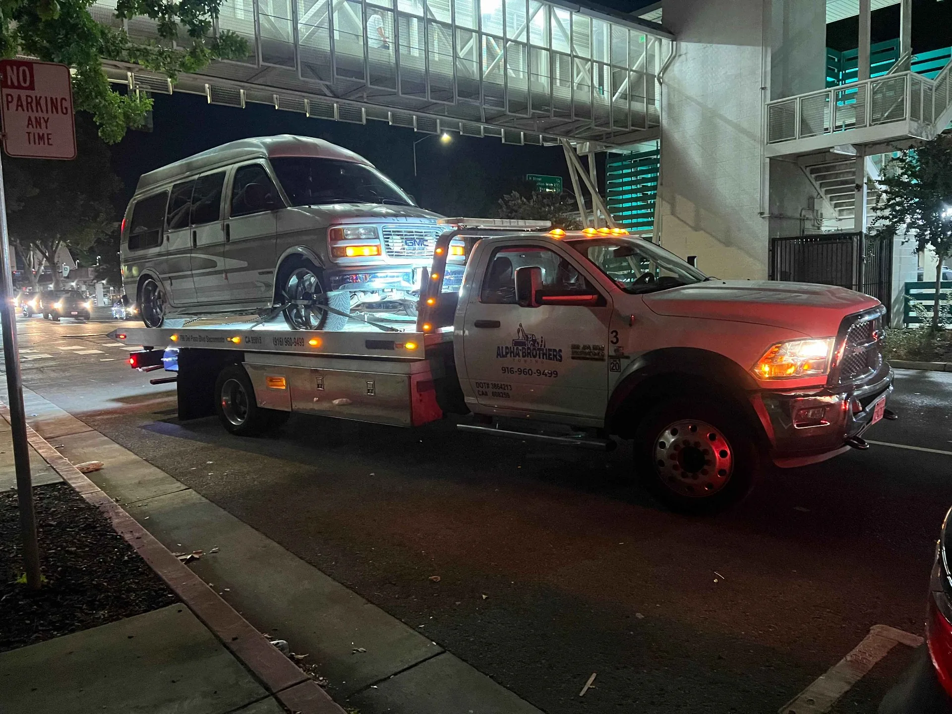Night-time tow of a van under a downtown Sacramento bridge by Alpha Brothers